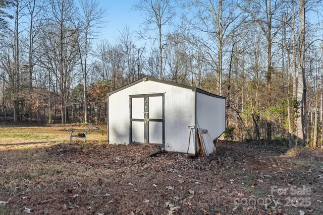a backyard of a house with tub and barbeque oven