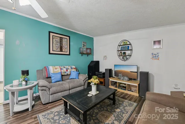 a living room with furniture and paintings on the wall