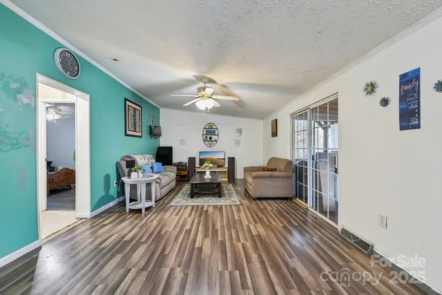a living room with furniture and a wooden floor