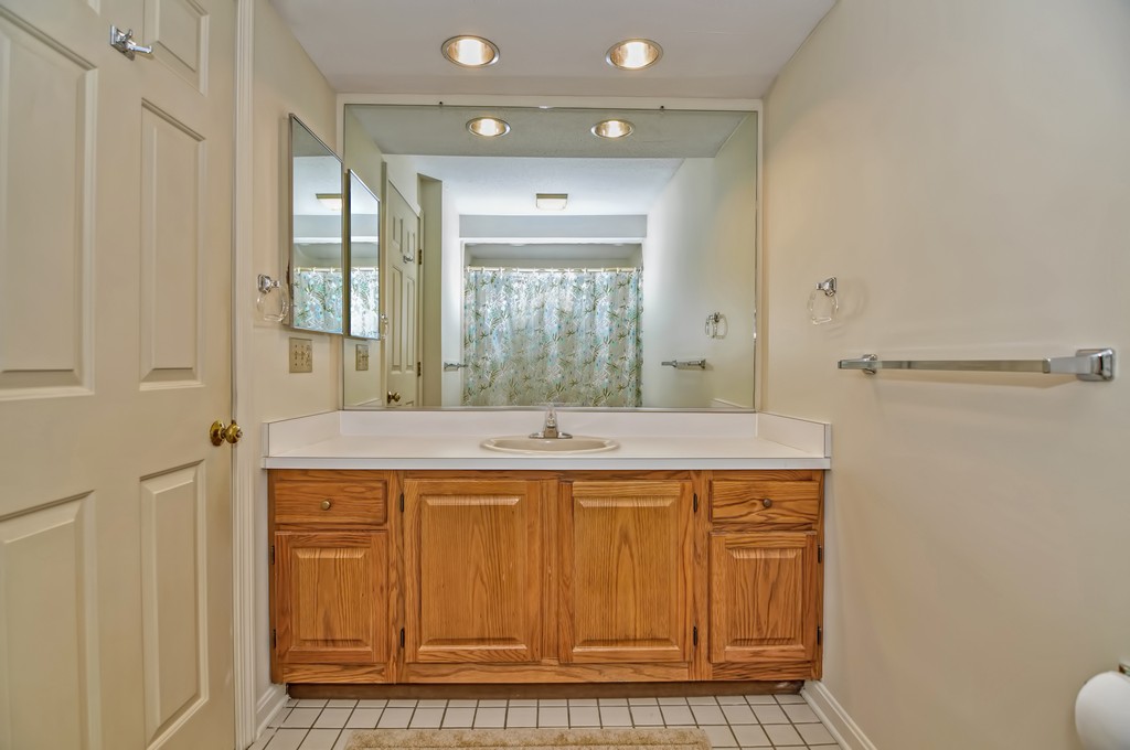 125 Stone Ridge Road, Unit 125 Franklin, MA 02038 - Photo 14 of 24 a bathroom with a sink a mirror and a shower
