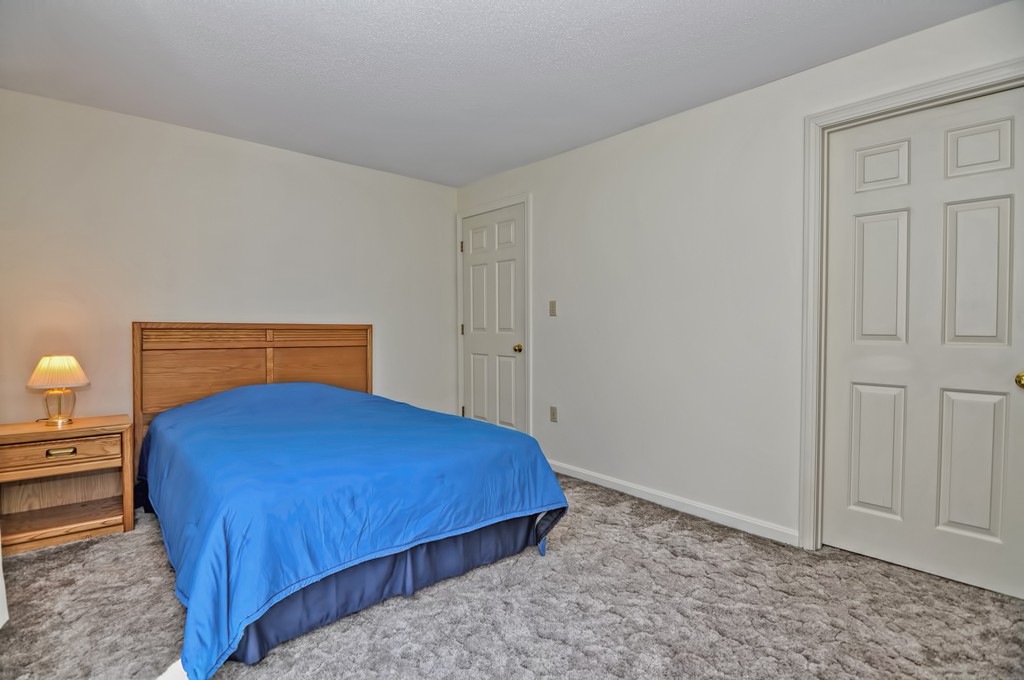 125 Stone Ridge Road, Unit 125 Franklin, MA 02038 - Photo 18 of 24 a bedroom with a bed and utility room