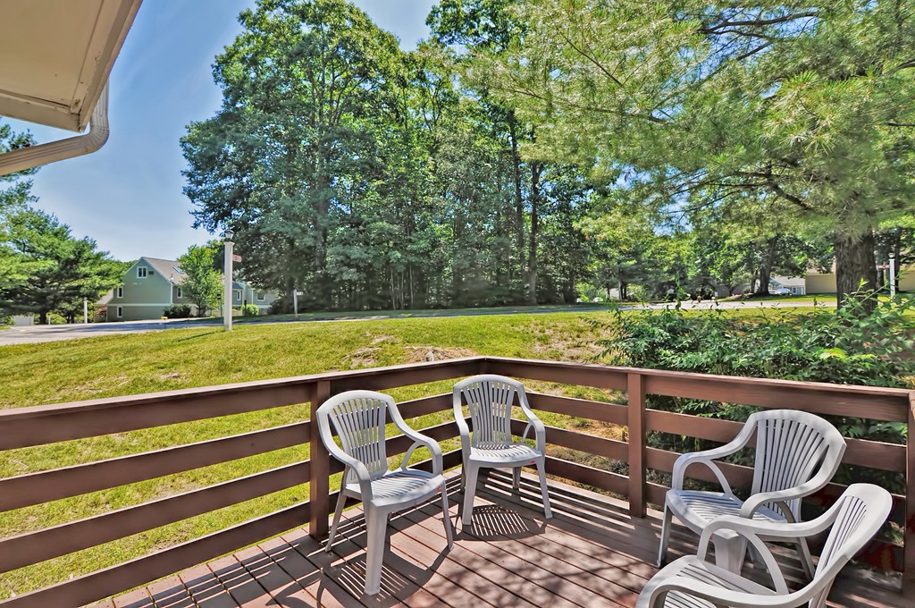 125 Stone Ridge Road, Unit 125 Franklin, MA 02038 - Photo 20 of 24 a view of a swimming pool with chairs in back yard of the house