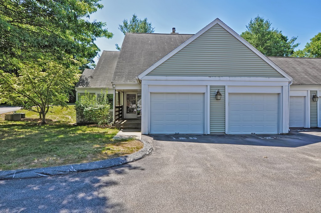 125 Stone Ridge Road, Unit 125 Franklin, MA 02038 - Photo 2 of 24 a front view of a house with garden