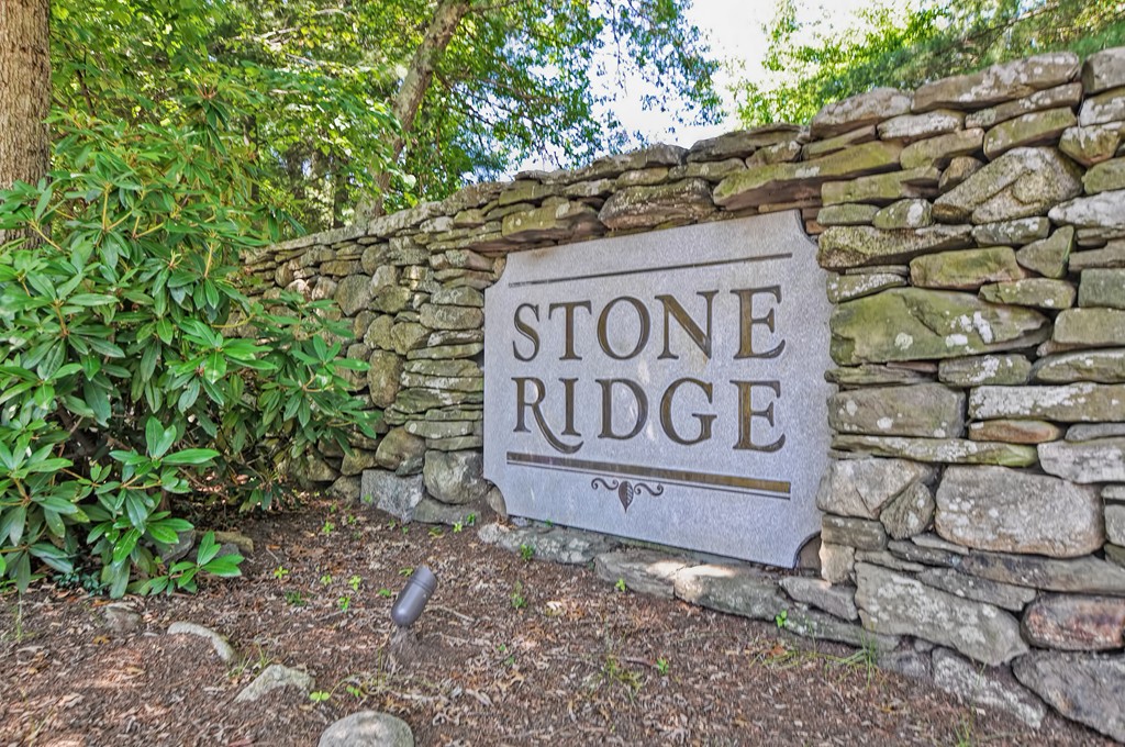 125 Stone Ridge Road, Unit 125 Franklin, MA 02038 - Photo 24 of 24 a sign that is sitting on a brick wall