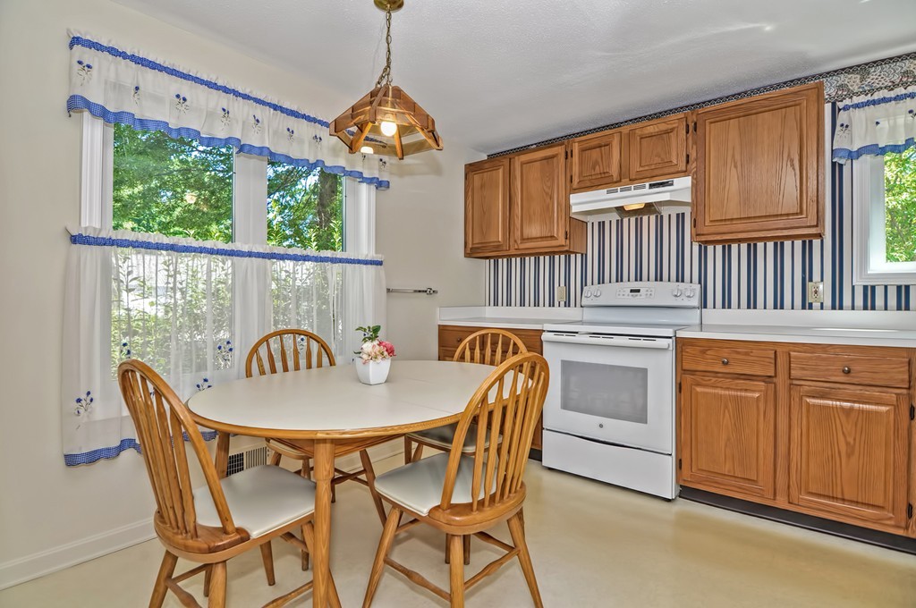 125 Stone Ridge Road, Unit 125 Franklin, MA 02038 - Photo 5 of 24 a view of a dining room with furniture window and wooden floor