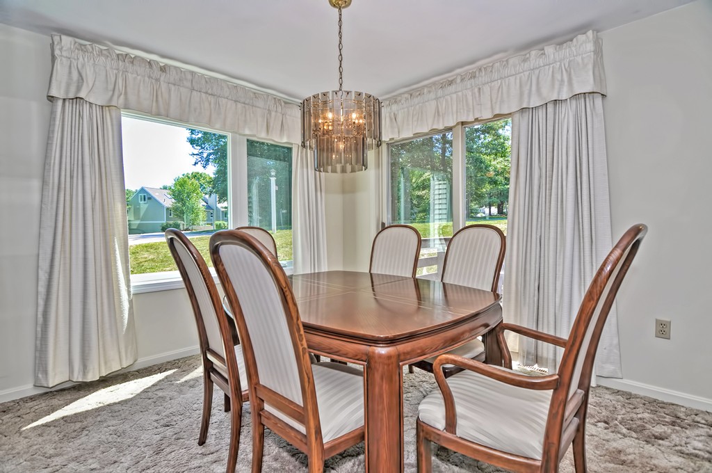 125 Stone Ridge Road, Unit 125 Franklin, MA 02038 - Photo 6 of 24 a dining room with furniture a chandelier and wooden floor
