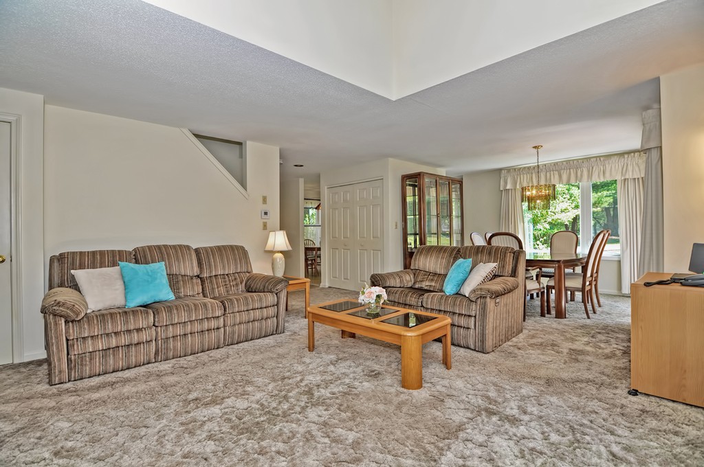 125 Stone Ridge Road, Unit 125 Franklin, MA 02038 - Photo 10 of 24 a living room with furniture and a large window