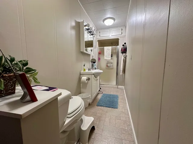 a room with furniture a air conditioner and a mirror