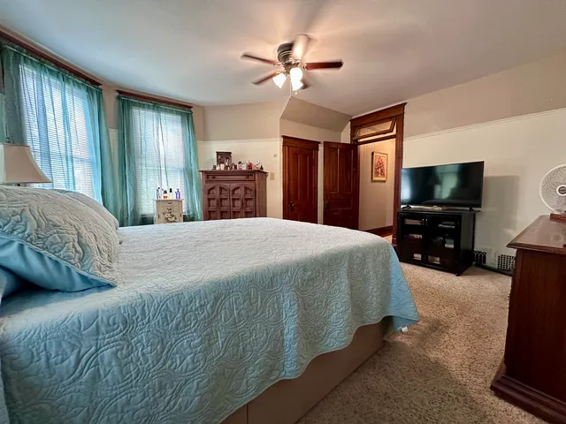 a bedroom with a bed and a chandelier