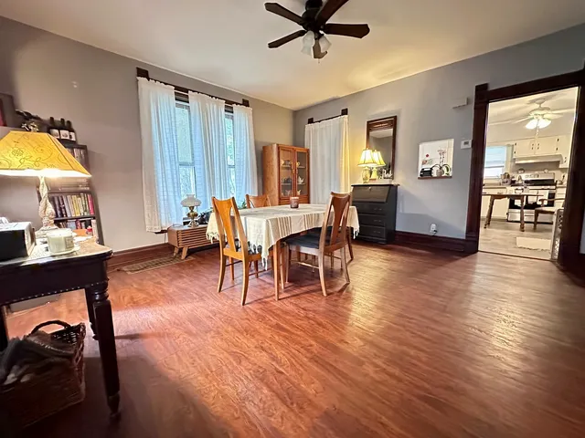 a view of a a dining room with furniture window and wooden floor