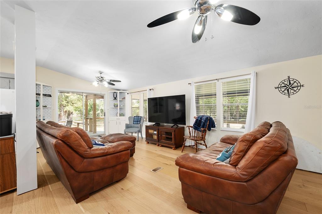 7870 Southwest 25th Place Bell, FL 32619 - Photo 63 of 99 a living room with furniture flat screen tv and a large window