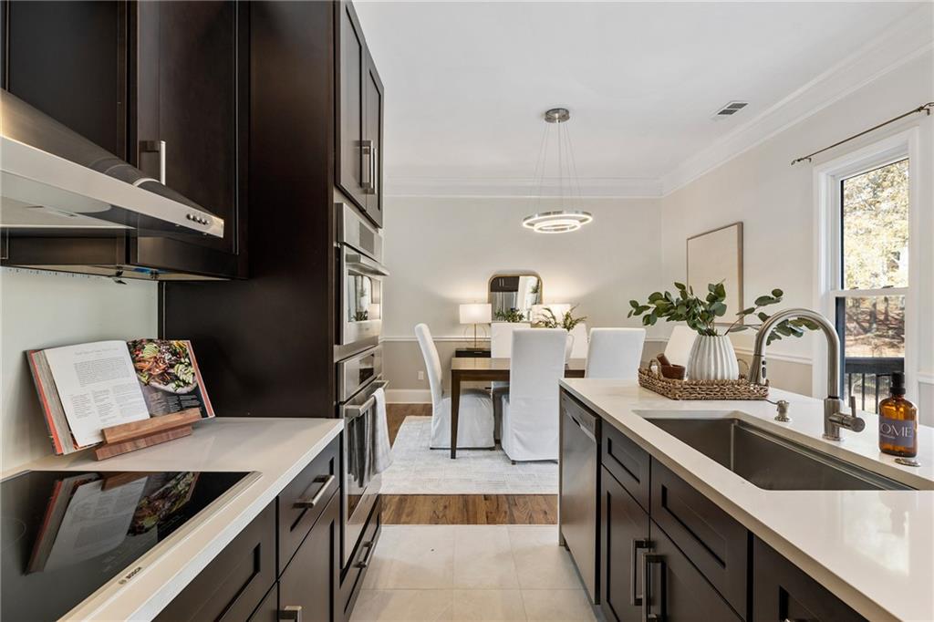 14440 Cogburn Road Alpharetta, GA 30004 - Photo 17 of 62 a kitchen with a stove and a sink