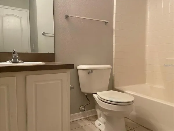 a white toilet sitting next to a bathroom sink