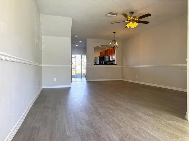 an empty room with wooden floor and painting on the wall