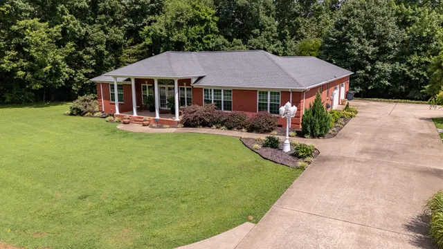 a view of a house with swimming pool and sitting area