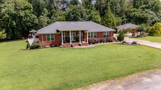 a view of a house with garden and sitting area