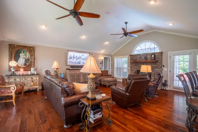 a living room with furniture a chandelier and a window