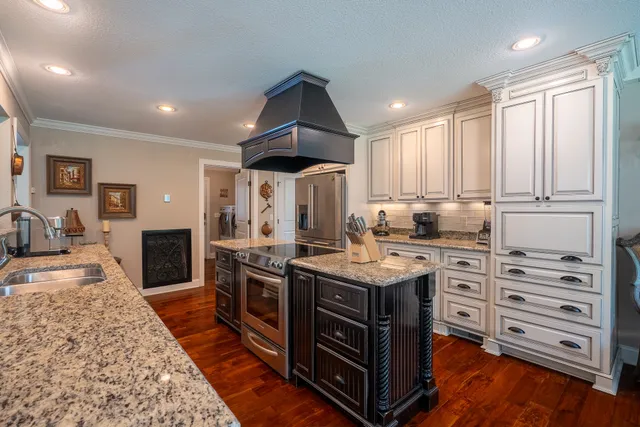 a kitchen with a sink a stove and refrigerator