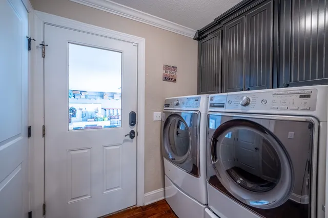 a bathroom with a granite countertop double vanity sink a mirror and a toilet