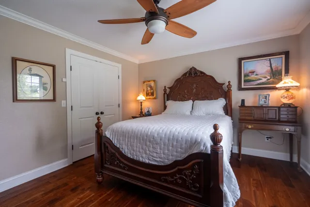 a spacious bedroom with a bed and a dresser