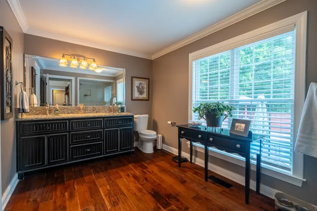 a room with wooden floor and a window