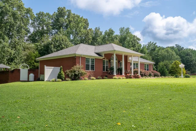 a front view of a house with a garden