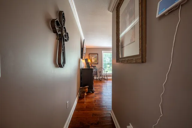 a bedroom with a bed a lamp and a large window