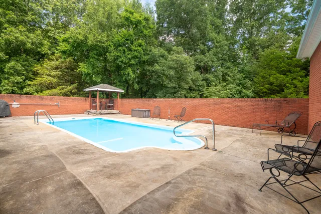 a view of a house with swimming pool and sitting area