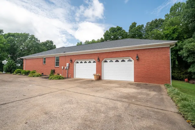 a yellow house with trees in front of it