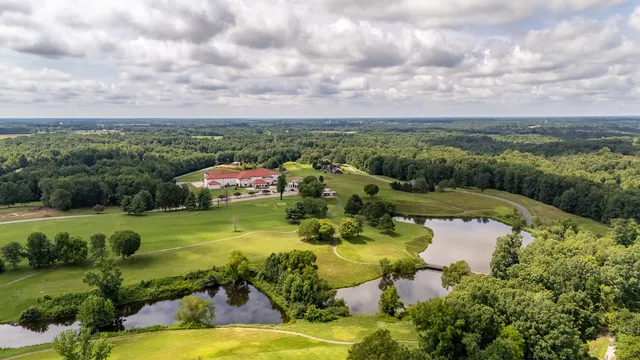 an aerial view of a house with a yard