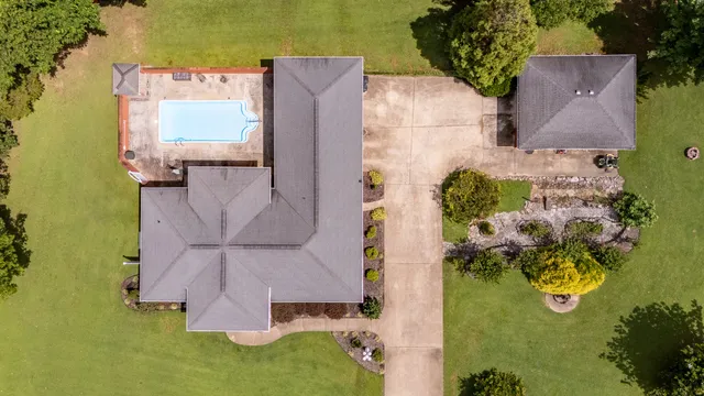 an aerial view of a house with swimming pool outdoor seating and yard