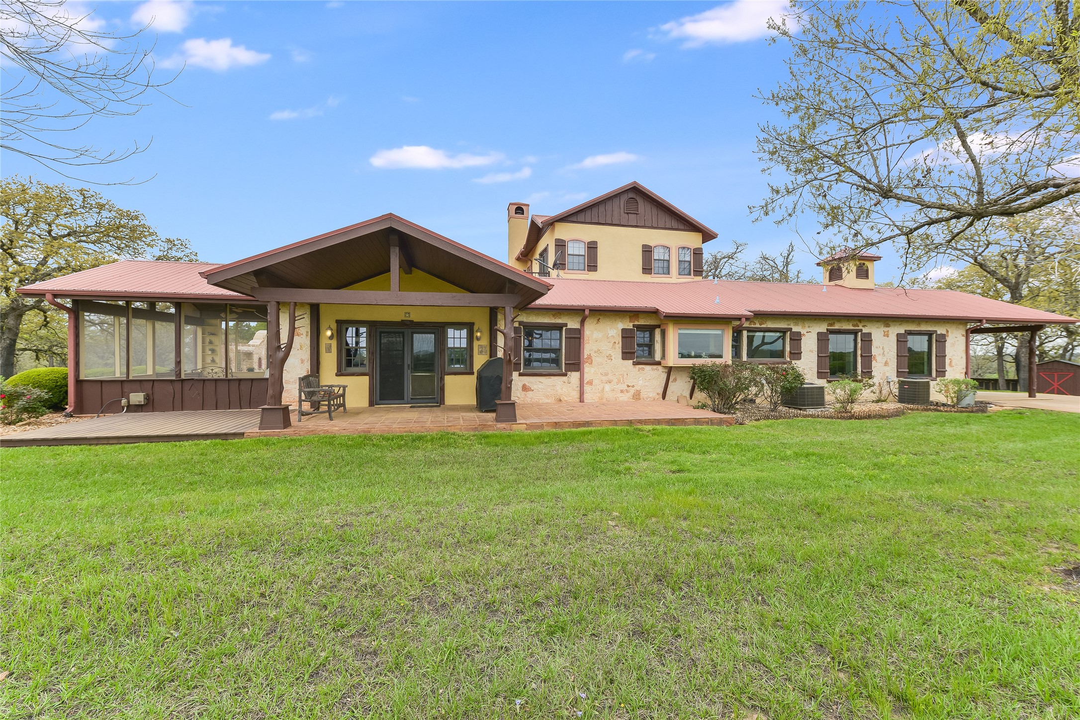 363 Paint Creek S Road, Unit A Paige, TX 78659 - Photo 8 of 28 A classic ranch home showcasing a blend of stucco and stone, with a spacious screened porch for outdoor enjoyment.