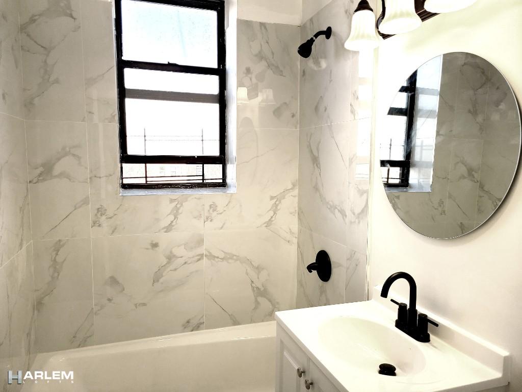 36 West 138th Street, Unit 52 Manhattan, NY 10037 - Photo 9 of 11 a bathroom with a sink and a mirror