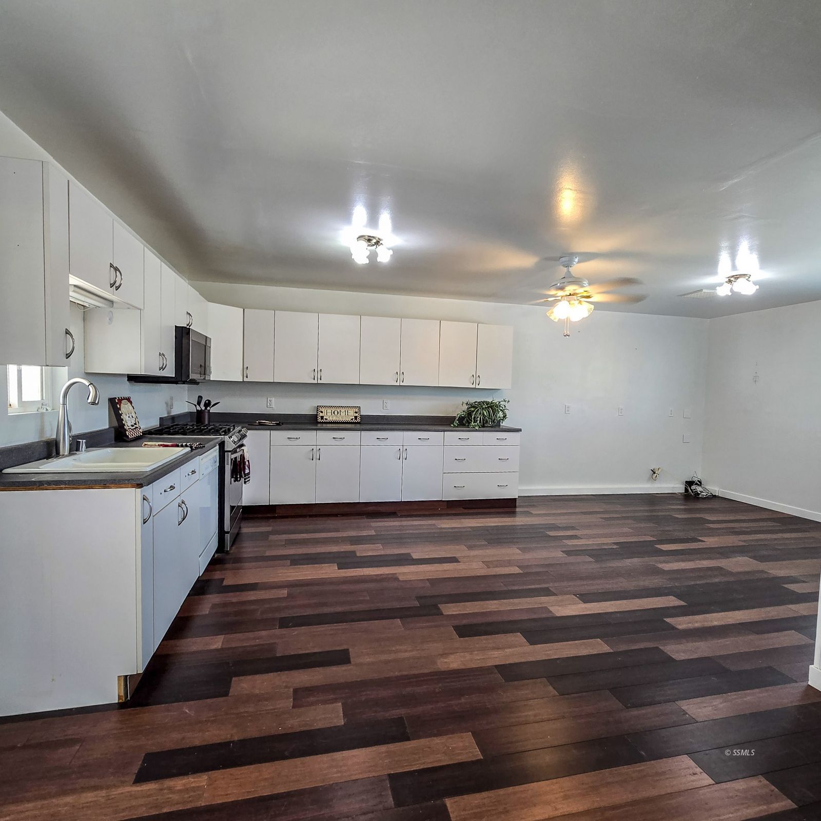 1436 Mayo Street Ridgecrest, CA 93555 - Photo 9 of 29 a large white kitchen with kitchen island a sink stainless steel appliances and cabinets