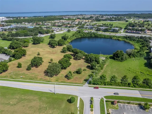 an aerial view of a houses with a lake view