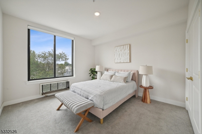 45 South Grove Street, Unit 232 East Orange, NJ 07018 - Photo 11 of 22 a bedroom with a bed and a large window