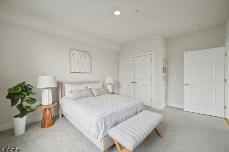 45 South Grove Street, Unit 232 East Orange, NJ 07018 - Photo 12 of 22 a bedroom with a bed and a potted plant