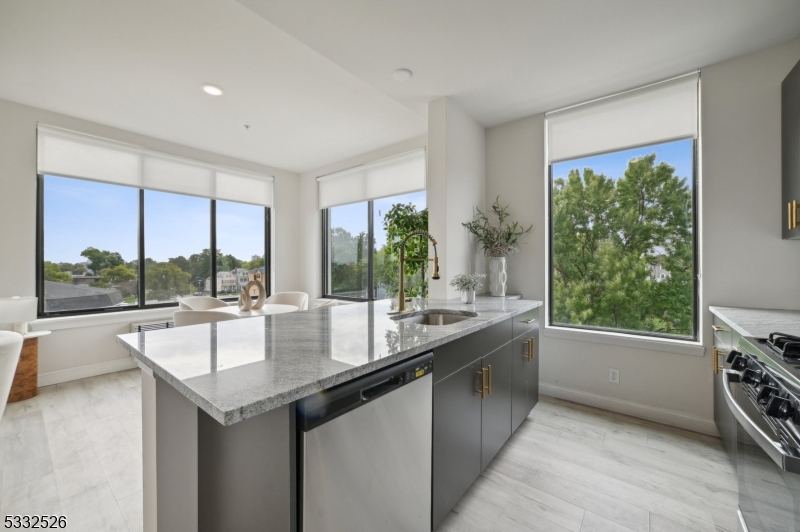 45 South Grove Street, Unit 232 East Orange, NJ 07018 - Photo 6 of 22 a large kitchen with kitchen island a large window in it
