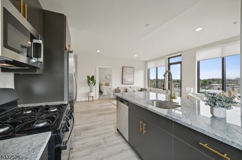 45 South Grove Street, Unit 232 East Orange, NJ 07018 - Photo 7 of 22 a kitchen with stainless steel appliances granite countertop a sink and a stove