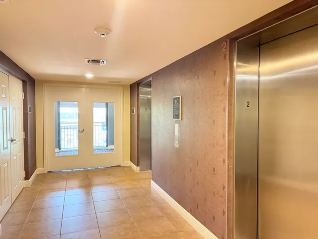 a view of a hallway with windows and closet area