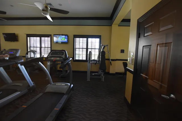 a living room with fireplace furniture and a large window