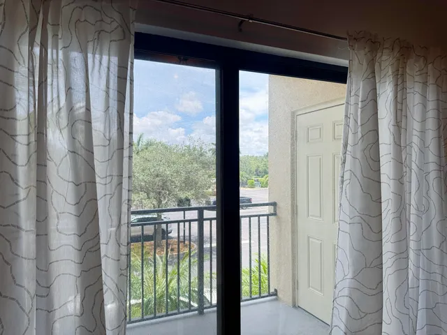 a view of a glass door with a balcony