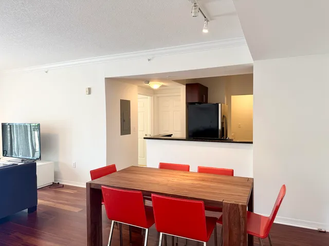 a view of a dining room with furniture and wooden floor