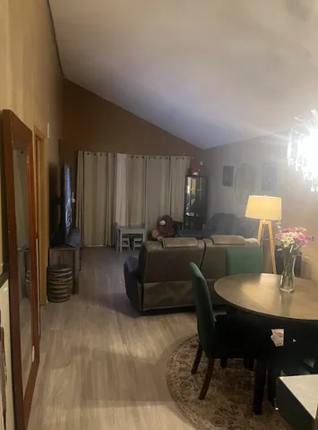 a kitchen with stainless steel appliances granite countertop a sink a stove and a refrigerator