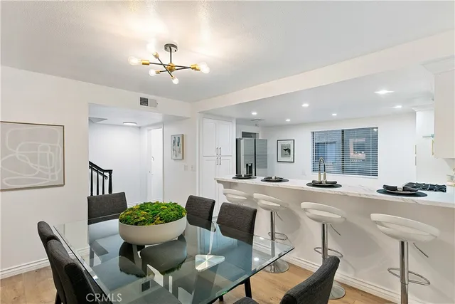 a view of a dining room with furniture and a chandelier