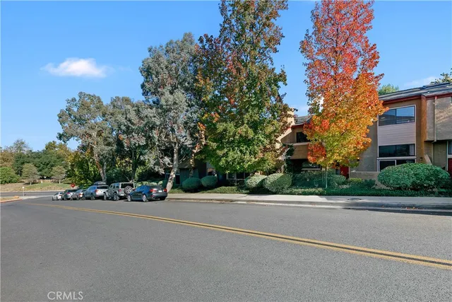 a road with a building and trees in the background