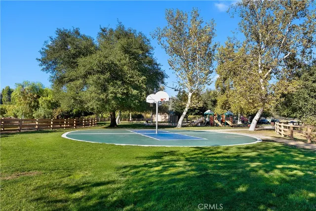 a view of a playground with basketball court