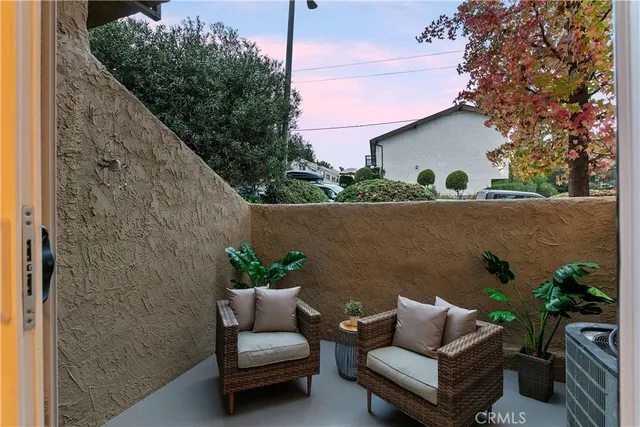 a view of patio with couches and a potted plant