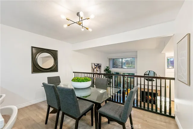 a view of a dining room with furniture and a chandelier