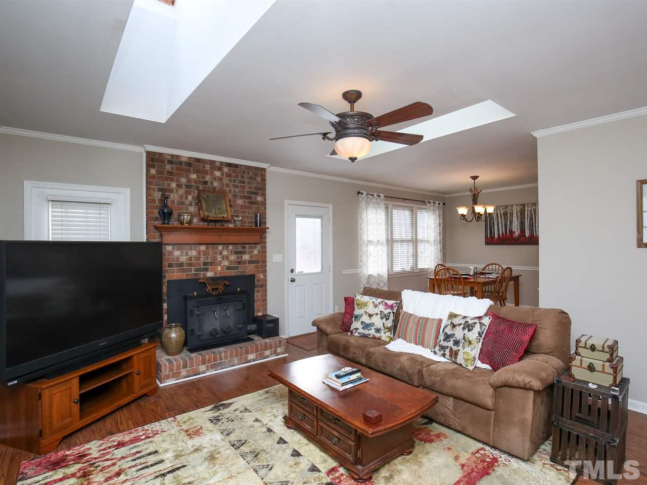 1811 Southview Road Durham, NC 27703 - Photo 4 of 30 a living room with furniture a flat screen tv and a fireplace